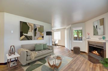 Everett apartment for rent - A living room with a grey couch and a fireplace.