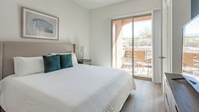 Oro Valley apartment for rent - A bedroom with a large bed and a painting on the wall.