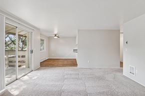 Gresham apartment for rent - A spacious living room with a carpeted floor and a ceiling fan.