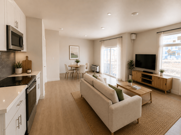 Richland apartment for rent - A modern living room with a beige sofa and a kitchen area with white cabinets.