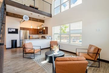 Flagstaff apartment for rent - A living room with a black coffee table and orange chairs.