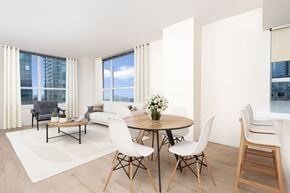 Seattle apartment for rent - A modern dining room with a round table and white chairs.
