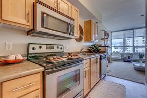 Seattle apartment for rent - A kitchen with a stove top oven and microwave above it.