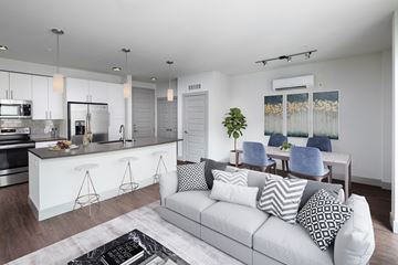 Bellevue apartment for rent - a living room with a white couch and a kitchen with a bar