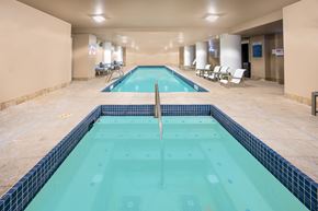 Tacoma apartment for rent - a swimming pool in the middle of a room with chairs and a pool