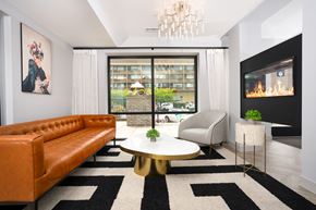 Tacoma apartment for rent - a living room with a leather couch and a coffee table and a fireplace
