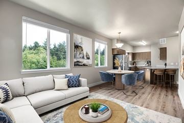 Newport apartment for rent - A living room with a white couch and a coffee table in front of a window.