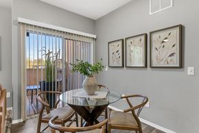 Tucson apartment for rent - A dining room with a glass table and chairs.