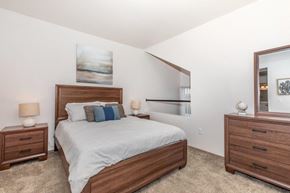 Tucson apartment for rent - A bedroom with a bed, nightstands, and a mirror.