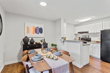 Beaverton apartment for rent - A modern kitchen with a dining table set for two.