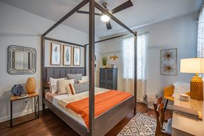 Lewisville apartment for rent - Discovery at the Realm Apartments Bedroom with canopy bed and ceiling fan