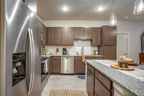 Lewisville apartment for rent - Discovery at the Realm Apartments kitchen with stainless steel appliances and large kitchen island