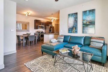 Kyle apartment for rent - A living room with a blue couch and a coffee table.