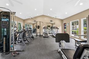 Austell apartment for rent - A spacious gym with a variety of equipment including treadmills, elliptical machines, and a weight machine.