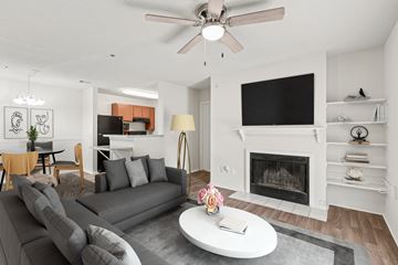 Austell apartment for rent - A living room with a grey couch and a fireplace.