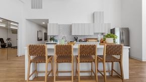Richland apartment for rent - a kitchen with a long island with bar stools in front of a white counter