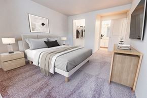 Tacoma apartment for rent - A bedroom with a bed, nightstand, and a carpeted floor.