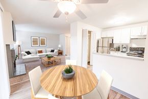 Tacoma apartment for rent - A modern dining room with a wooden table and white chairs.