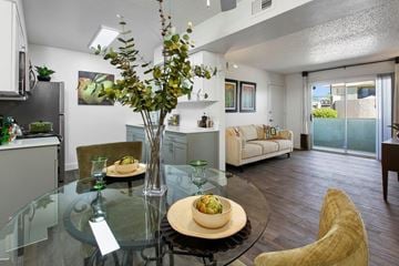 Phoenix apartment for rent - A modern dining room with a glass table and chairs.