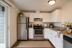Washougal apartment for rent - A kitchen with white cabinets and a stainless steel refrigerator.