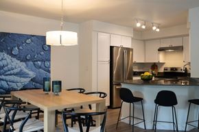 Bellevue apartment for rent - A kitchen with a table and chairs in front of a refrigerator.