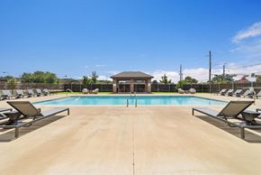 Longview apartment for rent - A large outdoor swimming pool with sun loungers and a pavilion.