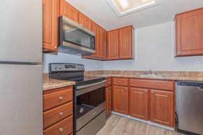Tucson apartment for rent - Kitchen with wood cabinets and stainless appliances at Peak at Oro Valley Apartments, Tucson, Arizona