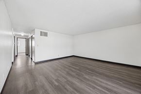 Kennewick apartment for rent - A room with wood flooring and white walls.
