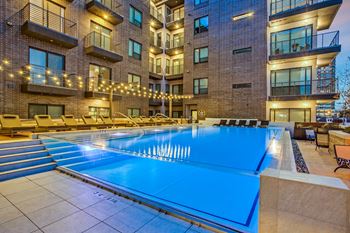 Elevated rooftop pool and expansive sundeck with panoramic city views