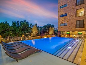 Dallas apartment for rent - a swimming pool in front of a building