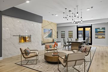 Grand Prairie apartment for rent - A modern living room with a fireplace and a large painting on the wall.