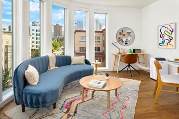 Seattle apartment for rent - A living room with a blue couch and a wooden coffee table.