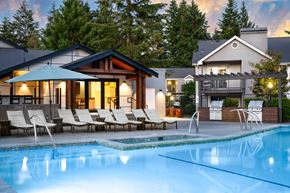 Silverdale apartment for rent - a swimming pool with lounge chairs next to a house