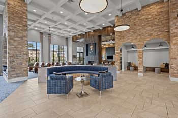 24/7 Two-story clubhouse with full kitchen, 2 way fireplace tv wall, and plush reclining seating