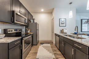 Austin apartment for rent - Lenox SoCo Apartments kitchen with stainless steel appliances and granite counter tops