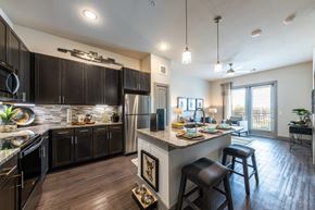 Kyle apartment for rent - Cromwell at Plum Creek Apartments Model Kitchen and Living Room