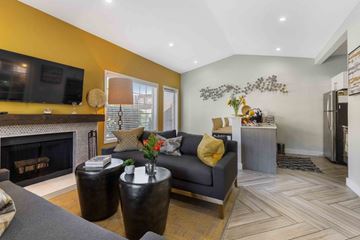 Everett apartment for rent - A living room with a grey couch and a fireplace.