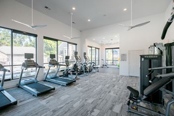 24-Hour fitness center with cardio equipment and strength training zone