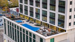 Salt Lake City apartment for rent - A large white building with a pool in the middle.