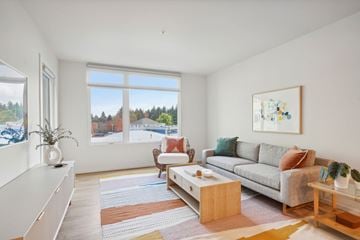 Portland apartment for rent - A living room with a grey couch, a coffee table, and a painting on the wall.