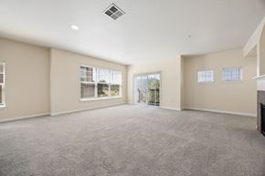 Gresham apartment for rent - Spacious living room with large windows and sliding glass door to patio or balcony at Springwater Crossing apartments in Gresham, Oregon 97030