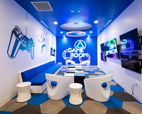 Bluffdale apartment for rent - A game room with a blue and white color scheme and a variety of gaming equipment.