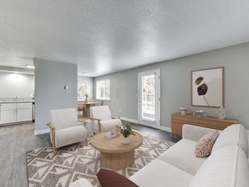 Vancouver apartment for rent - A living room with a white couch, a coffee table, and a rug.