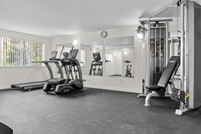 Spokane apartment for rent - A gym with treadmills, weights, and a clock on the wall.