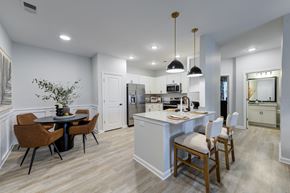 Wilson apartment for rent - A modern kitchen with a dining table and chairs.