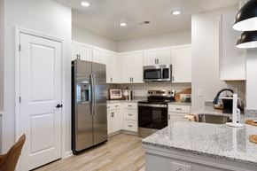 Wilson apartment for rent - A kitchen with a refrigerator, oven, and sink.