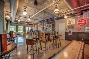 Lewisville apartment for rent - Discovery at the Realm Apartments club room with bar stool seating and game boards