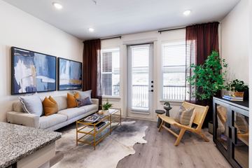 Celina apartment for rent - A living room with a couch, a coffee table, and a painting on the wall.