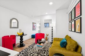 Boise apartment for rent - A living room with a leopard print rug and a yellow couch.