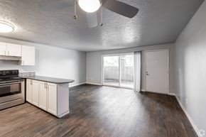 Vancouver apartment for rent - Open floorplan with kitchen island looking out into living room and patio at The Groove apartments in the Hazel Dell 98665 neighborhood in Vancouver, Washington.